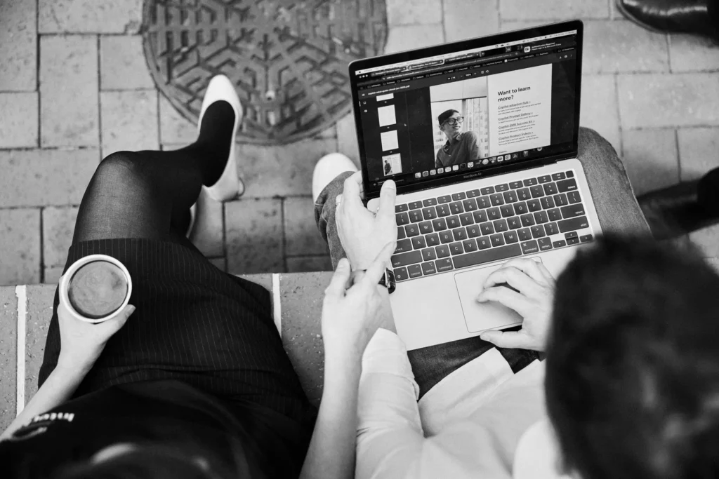 Two people looking at a laptop