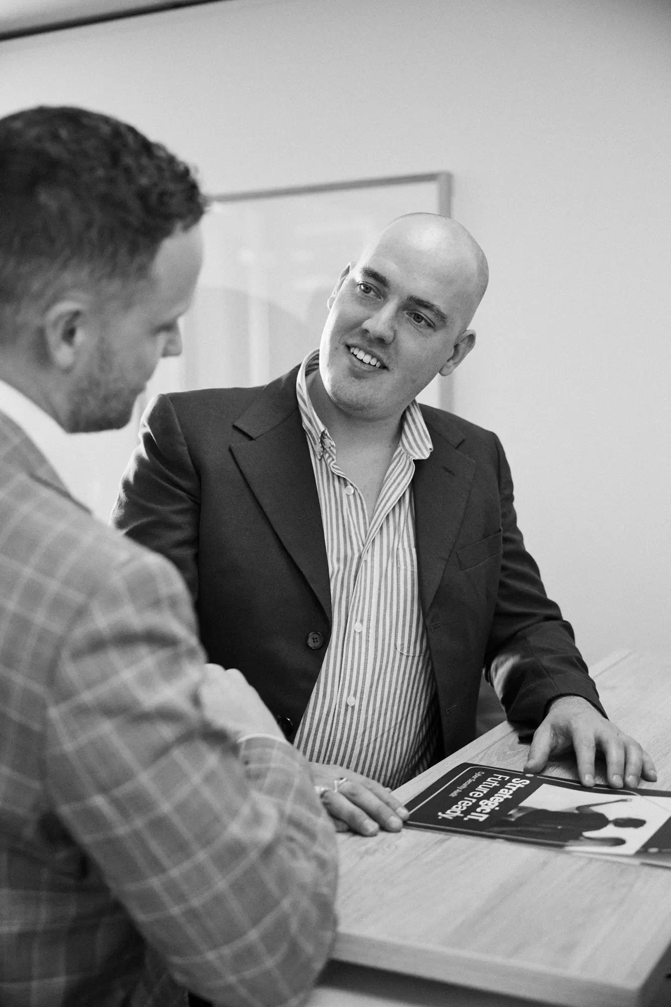Two people in discussion over a laptop