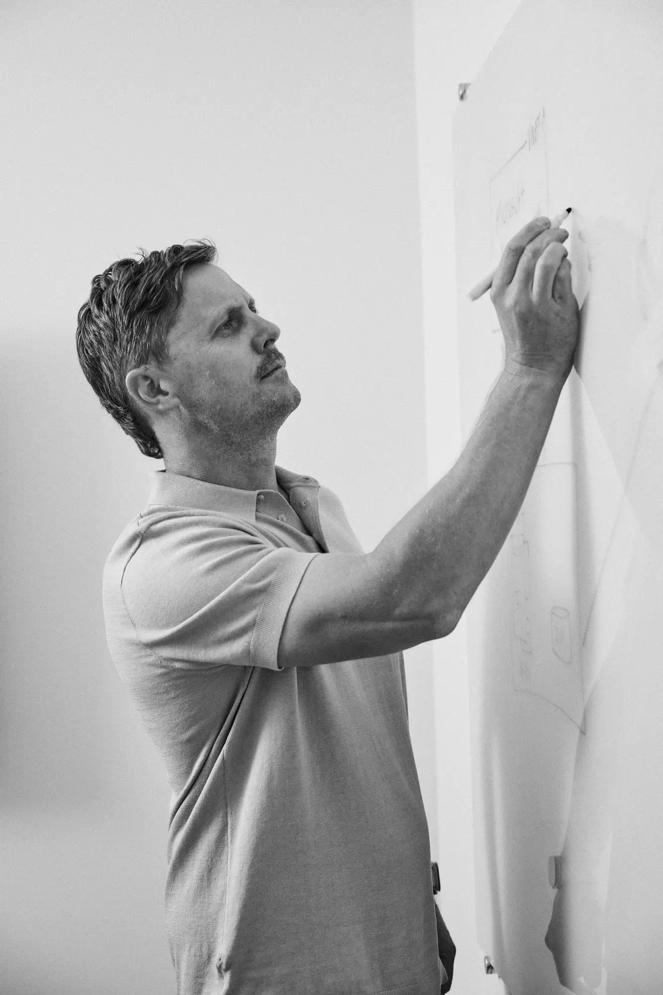 A man writing on a white board