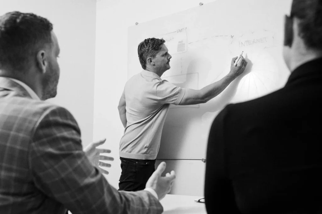 A man writing on a whiteboard