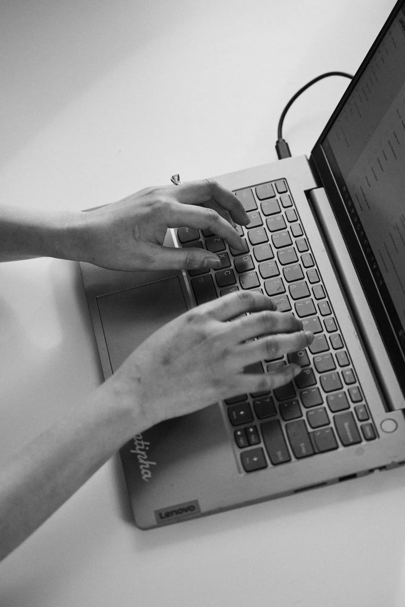 A person typing on a laptop